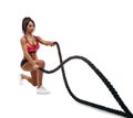 Beautiful fitness girl doing training using crossfit rope
