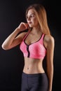 Beautiful fitness girl posing on black background Royalty Free Stock Photo