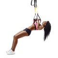 Beautiful fitness woman do Inverted Row with trx suspensions