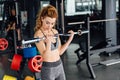Beautiful fitness woman lifting barbell. Royalty Free Stock Photo
