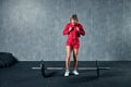 Beautiful fitness woman lifting barbell. Sporty woman lifting weights. Fit girl exercising building muscles. Royalty Free Stock Photo