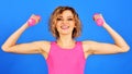 Beautiful fitness woman lifting dumbbells. Active sporty athletic girl in sportswear doing exercise. Royalty Free Stock Photo