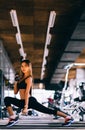Beautiful fitness woman lifting dumbbells . Fitness sporty girl exercising in gym Royalty Free Stock Photo