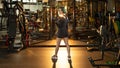 Beautiful fitness woman with lifting dumbbells . Sporty girl showing her well trained body . Well-developed muscles by strength Royalty Free Stock Photo