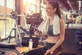 Beautiful fitness woman with smart phone and towel relaxing after sports training at gym Royalty Free Stock Photo