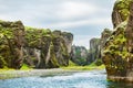 Beautiful Fjadrargljufur canyon with river and big rocks.