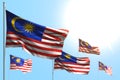 Beautiful 5 flags of Malaysia are waving against blue sky photo with selective focus - any celebration flag 3d illustration