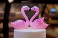 Beautiful figure of flamingos, a symbol of love. Two pink flamigo figures kissing, happy Valentine`s day. Royalty Free Stock Photo