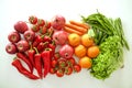 Beautiful flat lay composition with different kinds of mixed fresh fruits, vegetables and herbs assortment on white table top back Royalty Free Stock Photo