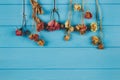 Beautiful flat lay composition with dry rosebuds and rose petals for preparing floral tea and home beauty treatments on blue