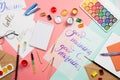 Beautiful flatlay arrangement with watercolors, brushes, glasses, brushpen, paints with good morning handlettering and other stati