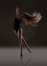 Flexible girl with long blonde hair dancing. Flying hair. Royalty Free Stock Photo