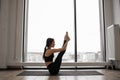 Fit young female training navasana pose indoors Royalty Free Stock Photo