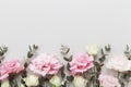 Beautiful floral border of pastel flowers and green eucalyptus leaves on gray table top view. Flat lay style. Royalty Free Stock Photo