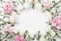 Beautiful floral frame of pastel flowers and eucalyptus leaves on white table top view. Flat lay style.