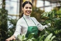 Beautiful florist working in flower shop while smiling and looking at a camera Royalty Free Stock Photo