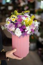 Beautiful flower arrangement with roses, limonium sinuatum, chrysanthemum flowers and other plants in the woman florist hands Royalty Free Stock Photo