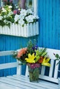 Beautiful flower bouquet on a garden bench Royalty Free Stock Photo