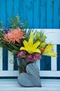 Beautiful flower bouquet on a garden bench Royalty Free Stock Photo