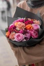 Beautiful flower bouquet with roses, cloves in hands. Florist. Flower shop Pink and orange flowers. Royalty Free Stock Photo