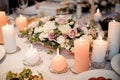 Beautiful flower composition and candles decorating a festive table Royalty Free Stock Photo