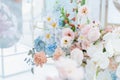 Beautiful flower composition by florist on wedding for bride and groom from roses, tulips, peonies, orchids on table. Decorators Royalty Free Stock Photo