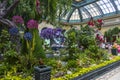 a beautiful flower garden at Bellagio Conservatory and Botanical Gardens with colorful flowers and lush green trees and plants Royalty Free Stock Photo