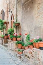 Beautiful flowerpots by a rustic wall in Tuscany - Italy Royalty Free Stock Photo