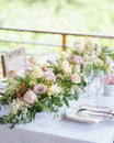Long flower arrangements in the middle of the dining table. Royalty Free Stock Photo