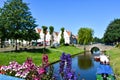 Beautiful flowers and in the background the old town of Friedrichstadt with a canal Royalty Free Stock Photo