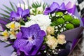 Beautiful flowers bouquet with purple orchids, white roses, lilly, alstroemeria, golden-daisy. A festive concept Royalty Free Stock Photo