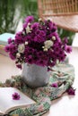 Beautiful flowers, bright cloth and book on wooden table