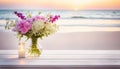 Beautiful flowers and candle by the beach on a large table with copy space