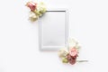 Beautiful flowers composition. Blank frame for text, white flowers on white background.