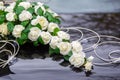 Beautiful flowers decoration on wedding car bonnet. White flowers on the hood of car