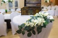 Beautiful flowers on elegant dinner table in wedding day. Decorations served on the festive table in blurred background Royalty Free Stock Photo