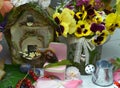 Beautiful flowers, tiny house and little snail on doll chair in the garden