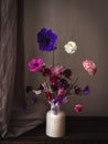 Beautiful flowers in vase on moody rustic background. Stylish flowers still life, artistic composition of lathyrus, anemone, Royalty Free Stock Photo