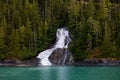 Beautiful flowing waterfall into the ocean in Endicott Arm, Alaska Royalty Free Stock Photo