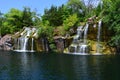 Light blue skies above flower waterfalls over red granite rocks Royalty Free Stock Photo