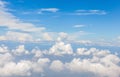 Beautiful fluffy white cumulus clouds in sunny blue sky. Royalty Free Stock Photo