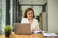 Beautiful and focused Asian businesswoman writing something on report Royalty Free Stock Photo