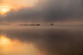 River in the fog, just before sunrise.Warm glow in the clouds from the first sunrays. Royalty Free Stock Photo