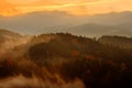 Beautiful foggy landscape. Cold misty foggy morning with twilight sunrise in a fall valley of Bohemian Switzerland park Royalty Free Stock Photo