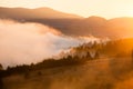 Beautiful foggy landscape in the sunrise mountains. Fantastic morning foggy autumn hills Royalty Free Stock Photo