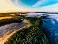 Beautiful foggy morning, aerial landscape. Lakes and green forest at sunrise. Ecology concept