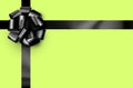 Beautiful foil black bow with ribbon on green background