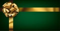 Beautiful foil golden bow with ribbon on green background Royalty Free Stock Photo