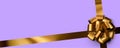 Beautiful foil golden bow with ribbon on purple background