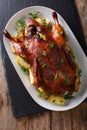 Beautiful food: baked whole duck with apples close-up on a platter. Vertical top view Royalty Free Stock Photo